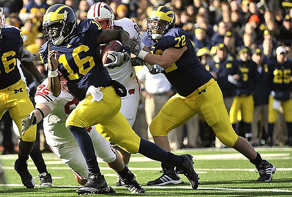 Denard Robinson (16) and Mark Huyge (72)