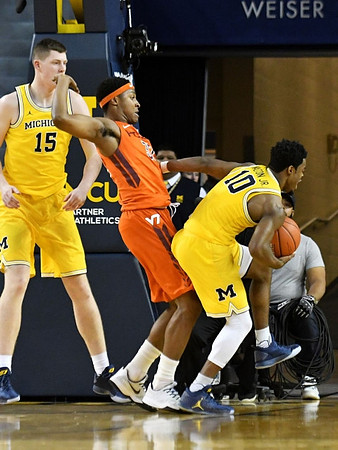 Jon Teske (15) and Derrick Walton Jr. (10)