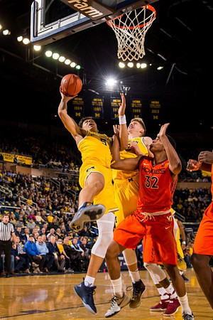 D.J. Wilson (5) and Moritz Wagner (13)