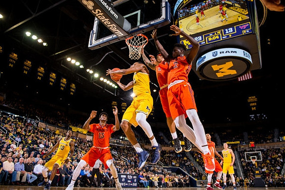 Derrick Walton Jr. (10), Zak Irvin (21), and Duncan Robinson (22)