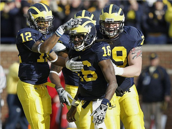 Roy Roundtree (12), Denard Robinson (16), and Perry Dorrestein (79)