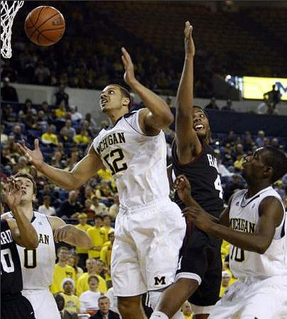 Zack Novak (0), Jordan Morgan (52), and Tim Hardaway Jr. (10)