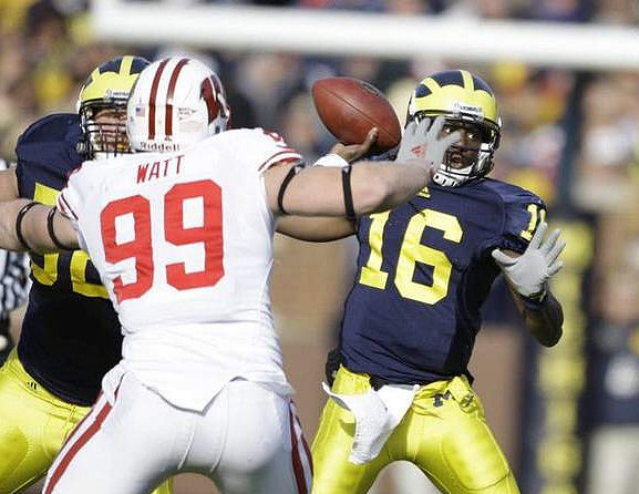 Stephen Schilling (52) and Denard Robinson (16)