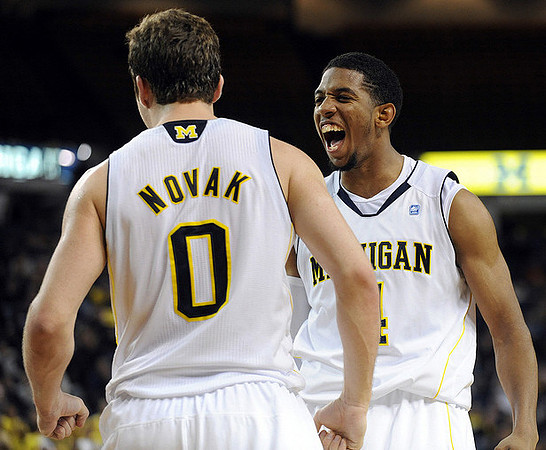 Zack Novak (0) and Darius Morris (4)
