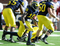 Patrick Omameh (65), Denard Robinson (16), and David Molk (50)