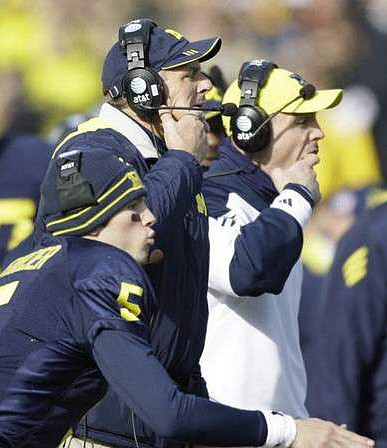 Tate Forcier (5) and Rich Rodriguez