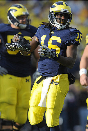 Stephen Schilling (52) and Denard Robinson (16)