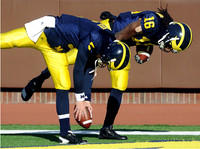 Tate Forcier (5) and Denard Robinson (16)