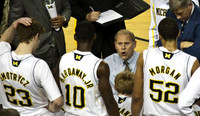 Evan Smotrycz (23), Tim Hardaway Jr. (10), Blake McLimans (22), John Beilein, and Jordan Morgan (52)