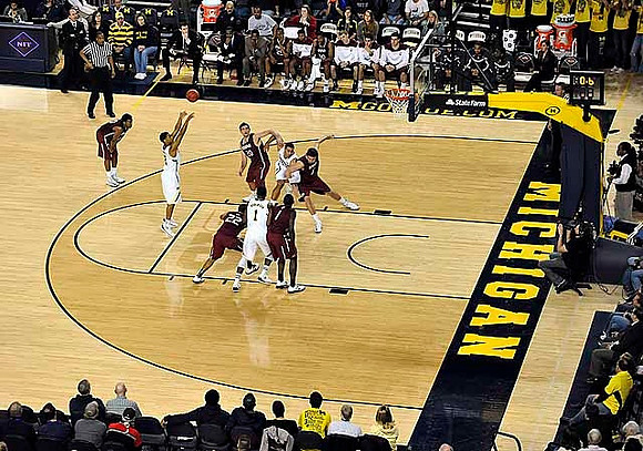 Glenn Robinson III (1), Trey Burke (3), and Jordan Morgan (52)