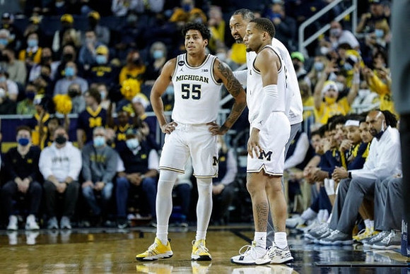 Eli Brooks (55), Juwan Howard, and DeVante' Jones (12)