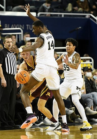 Moussa Diabate (14) and Eli Brooks (55)