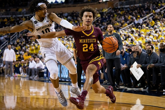 Frankie Collins (10) and Minnesota Head Coach Ben Johnson