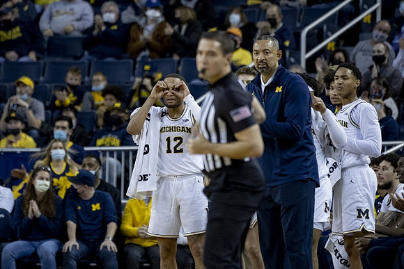 DeVante' Jones (12), Juwan Howard, and Kobe Bufkin (2)
