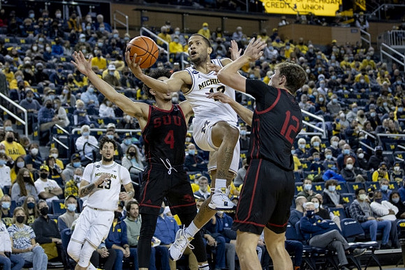 Brandon Johns Jr. (23) and DeVante' Jones (12)