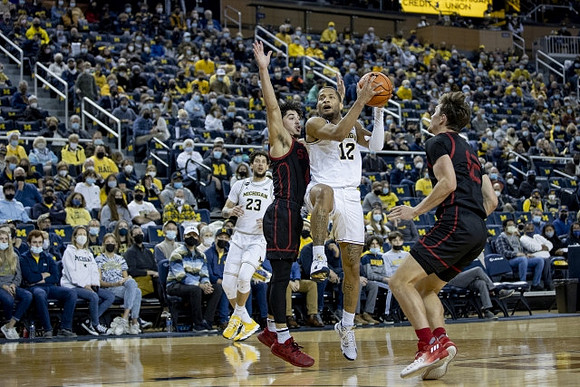 Brandon Johns Jr. (23) and DeVante' Jones (12)