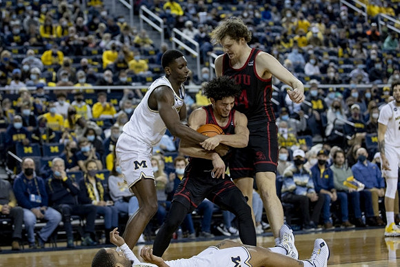 Moussa Diabate (14), DeVante' Jones (12), and Brandon Johns Jr. (23)