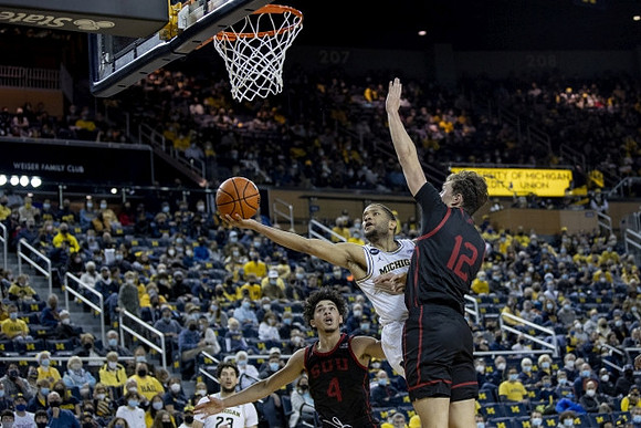 Brandon Johns Jr. (23) and DeVante' Jones (12)