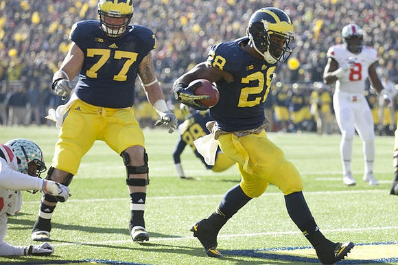 Taylor Lewan (77) and Fitzgerald Toussaint (28)