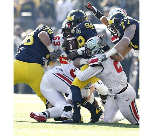 Erik Magnuson (78), Devin Gardner (98), and Taylor Lewan (77)