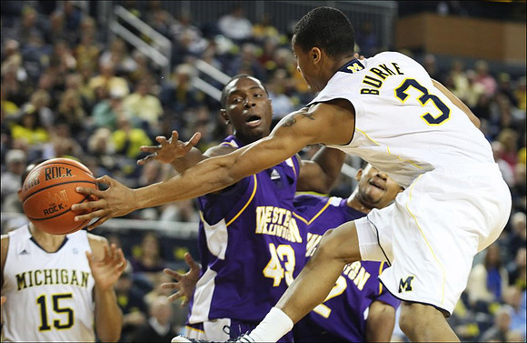 Trey Burke (3) and Jon Horford (15)