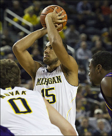 Zack Novak (0) and Jon Horford (15)