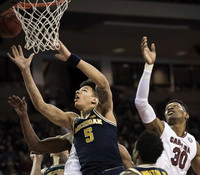 D.J. Wilson (5) and Derrick Walton Jr. (10)