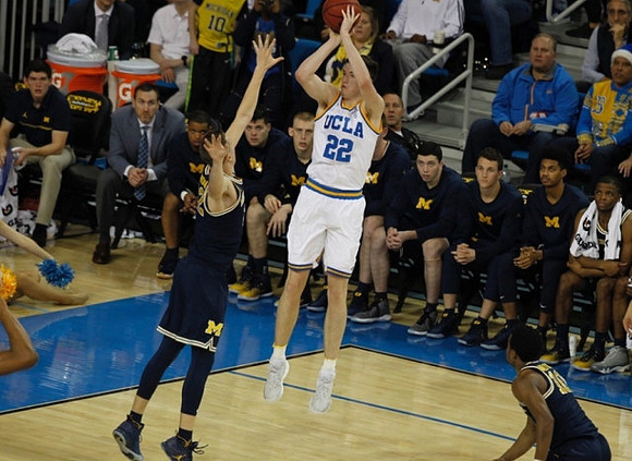 D.J. Wilson (5) and Derrick Walton Jr. (10)