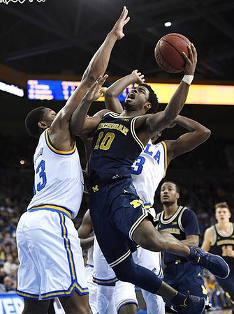 Derrick Walton Jr. (10), Muhammad-Ali Abdur-Rahkman (12), and Moritz Wagner (13)