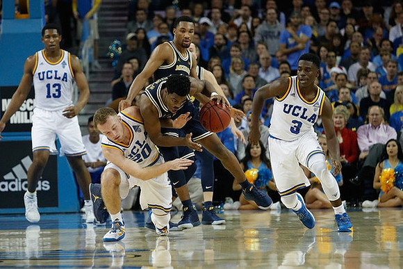 Derrick Walton Jr. (10) and Zak Irvin (21)
