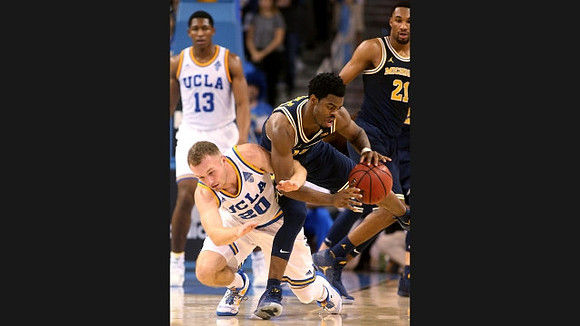 Derrick Walton Jr. (10) and Zak Irvin (21)