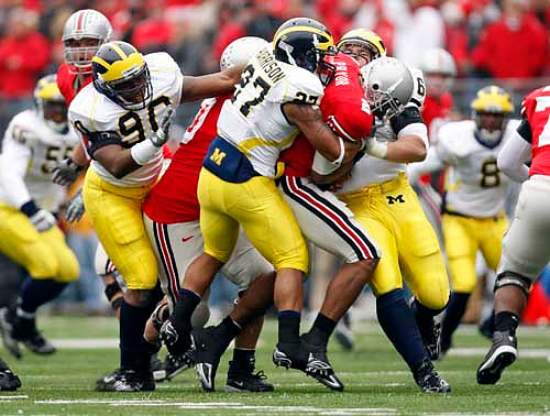 Brandon Harrison (27), Tim Jamison (90), Mike Martin (68), Brandon Graham (55), and Jonas Mouton (8)