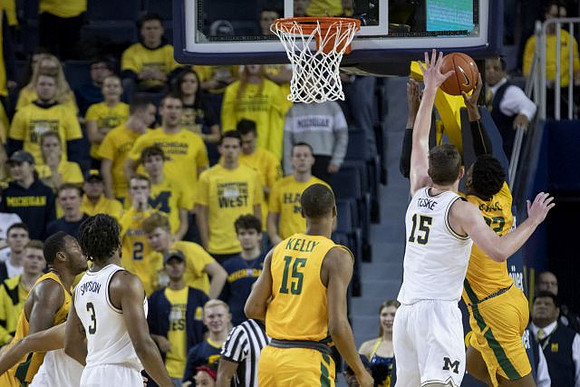 Zavier Simpson (3) and Jon Teske (15)