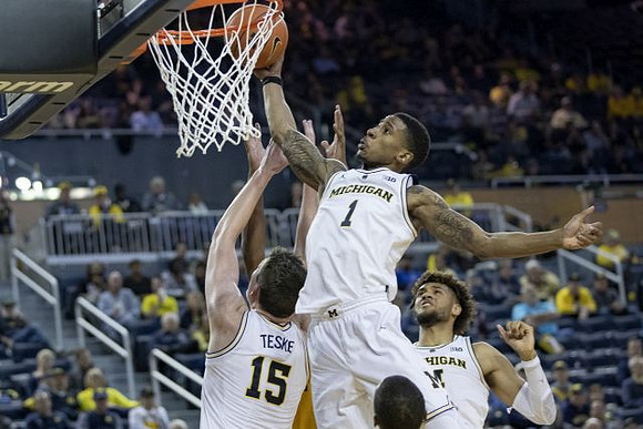 Jon Teske (15), Charles Matthews (1), and Isaiah Livers (4)