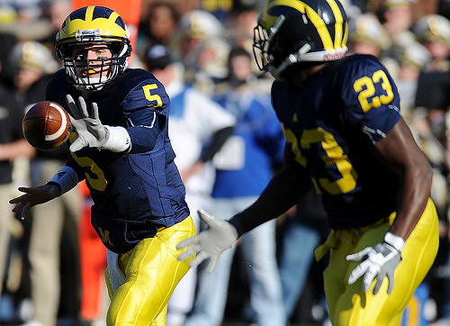Tate Forcier (5) and Carlos Brown (23)