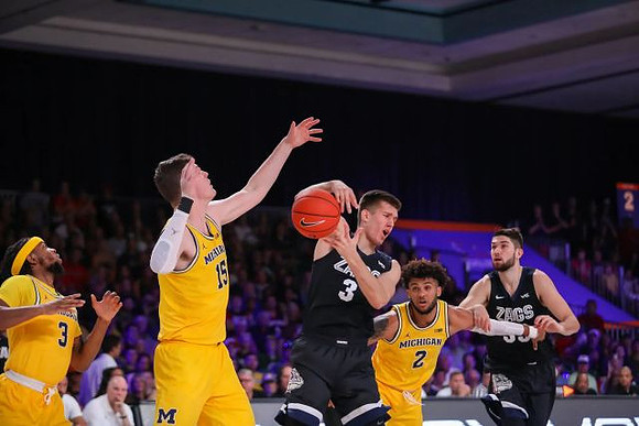 Zavier Simpson (3), Jon Teske (15), and Isaiah Livers (2)
