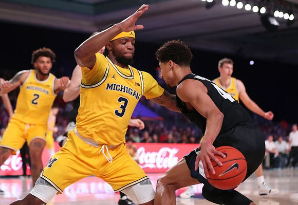 Isaiah Livers (2), Zavier Simpson (3), and Franz Wagner (21)