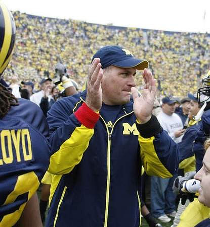 J.T. Floyd (12) and Rich Rodriguez