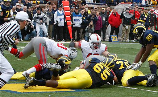 Tate Forcier (5), Patrick Omameh (65), Perry Dorrestein (79), and Martell Webb (80)