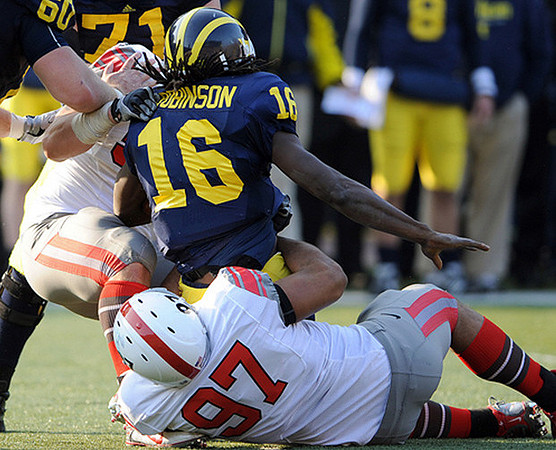 David Moosman (60), Mark Ortmann (71), and Denard Robinson (16)