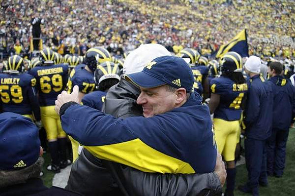 Tom Lindley (59), Erik Gunderson (69), Taylor Lewan (77), Rich Rodriguez, and Brandon Smith (4)