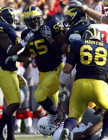 Donovan Warren (6), Brandon Graham (55), Jonas Mouton (8), and Mike Martin (68)