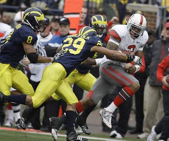 Jonas Mouton (8) and Troy Woolfolk (29)