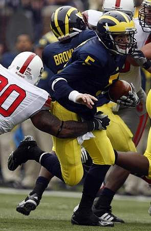 Tate Forcier (5) and Carlos Brown (23)
