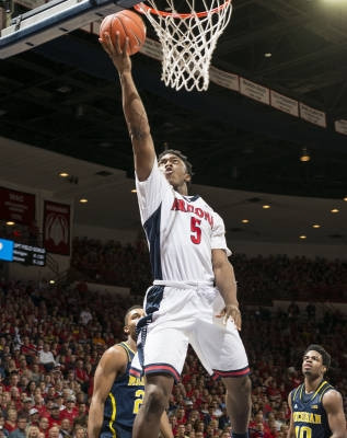 Zak Irvin (21) and Derrick Walton Jr. (10)