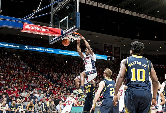 Aubrey Dawkins (24), Spike Albrecht (2), and Derrick Walton Jr. (10)