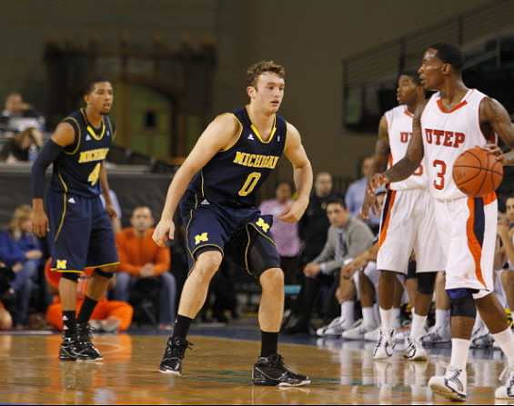 Zack Novak (0) and Darius Morris (4)