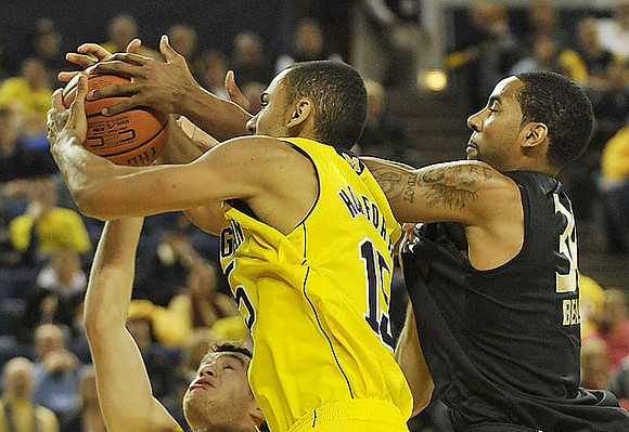 Zack Novak (0) and Jon Horford (15)