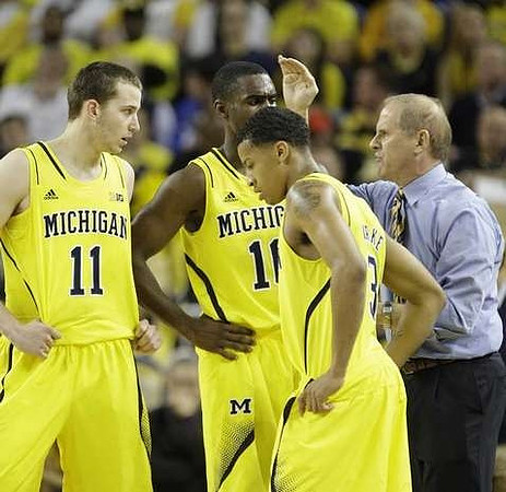 Nik Stauskas (11), John Beilein, Tim Hardaway Jr. (10), and Trey Burke (3)