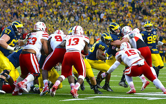Kyle Kalis (67), Fitzgerald Toussaint (28), and Devin Gardner (98)